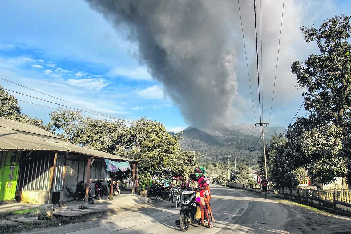 Villagers flee during an eruption of Mount Lewotobi Laki-Laki, in East Flores, Indonesia.