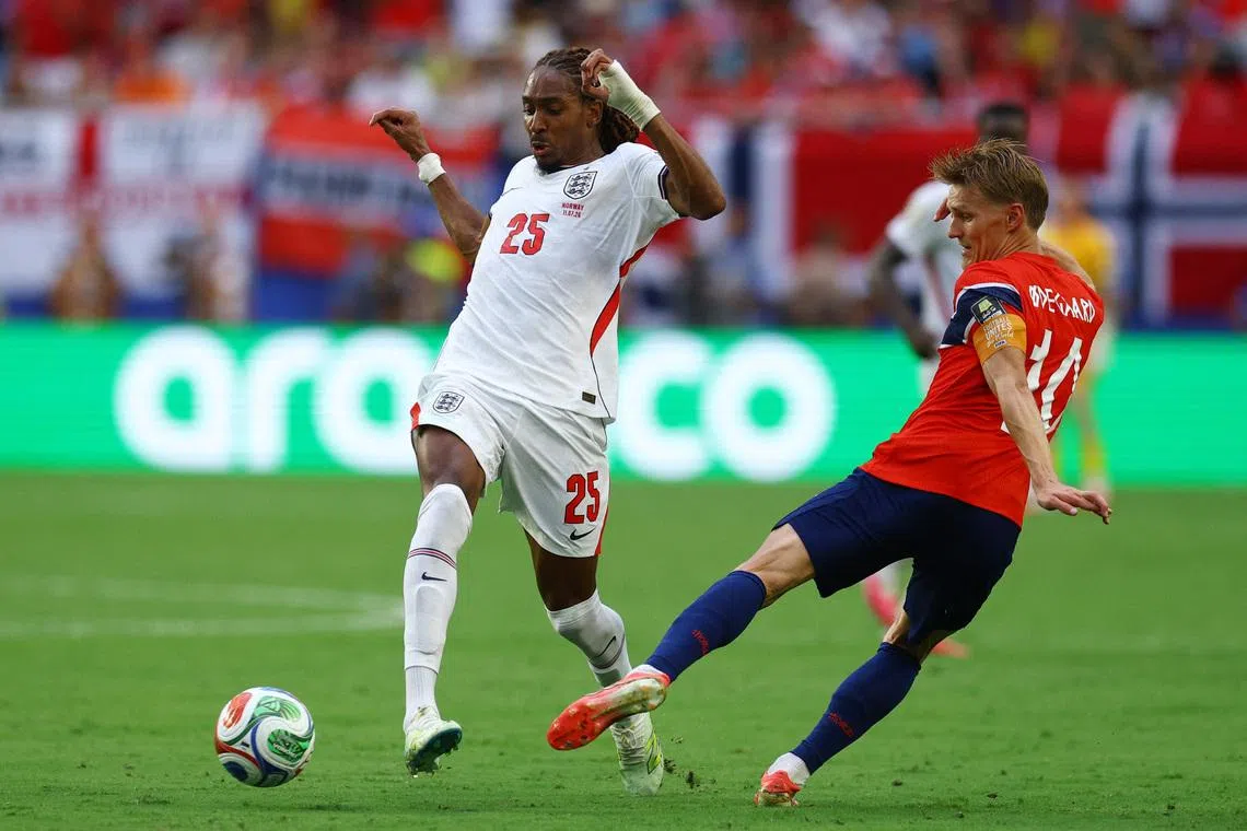 Soccer Football - FIFA World Cup 2026 - Quarter Final - Norway v England - Miami Stadium, Miami Gardens, Florida, U.S. - July 11, 2026 England's Djed Spence in action with Norway's Martin Odegaard IMAGN IMAGES via Reuters/Nathan Ray Seebeck