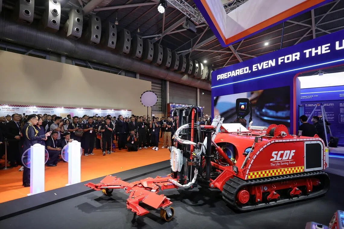 Second Minister for Home Affairs Sim Ann (second from left), accompanied by Singapore Civil Defence Force (SCDF) commisioner Eric Yap (left), unveiling the Vehicle Extrication Robot (VXR), the latest addition to SCDF's fleet of robots, during the Singapore-International Disaster and Emergency Management Expo, held together with the Asian Conference on Disaster Reduction (SIDEX-ACDR 2026) and in conjunction with the Fire Safety Asia Conference (FiSAC), at Singapore Expo Hall 3 on Oct 28, 2026.