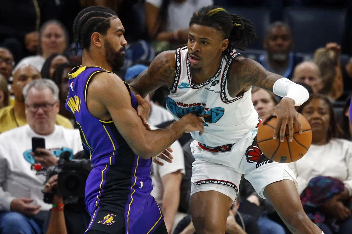 Nov 6, 2024; Memphis, Tennessee, USA; Memphis Grizzlies guard Ja Morant (12) drives to the basket as Los Angeles Lakers guard Gabe Vincent (7) defends during the first half at FedExForum. Mandatory Credit: Petre Thomas-Imagn Images/ File Photo