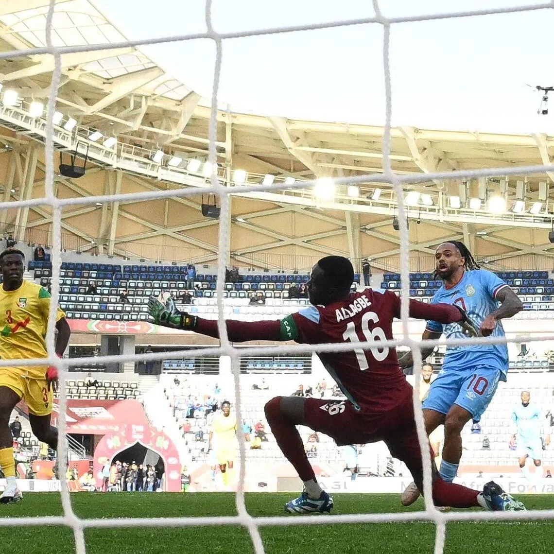 Democratic Republic Of Congo's forward Theo Bongonda scores the game's only goal past Benin's goalkeeper Saturnin Allagbe in their Africa Cup of Nations Group D football match at Al Medina Stadium in Rabat on Dec 23, 2025.