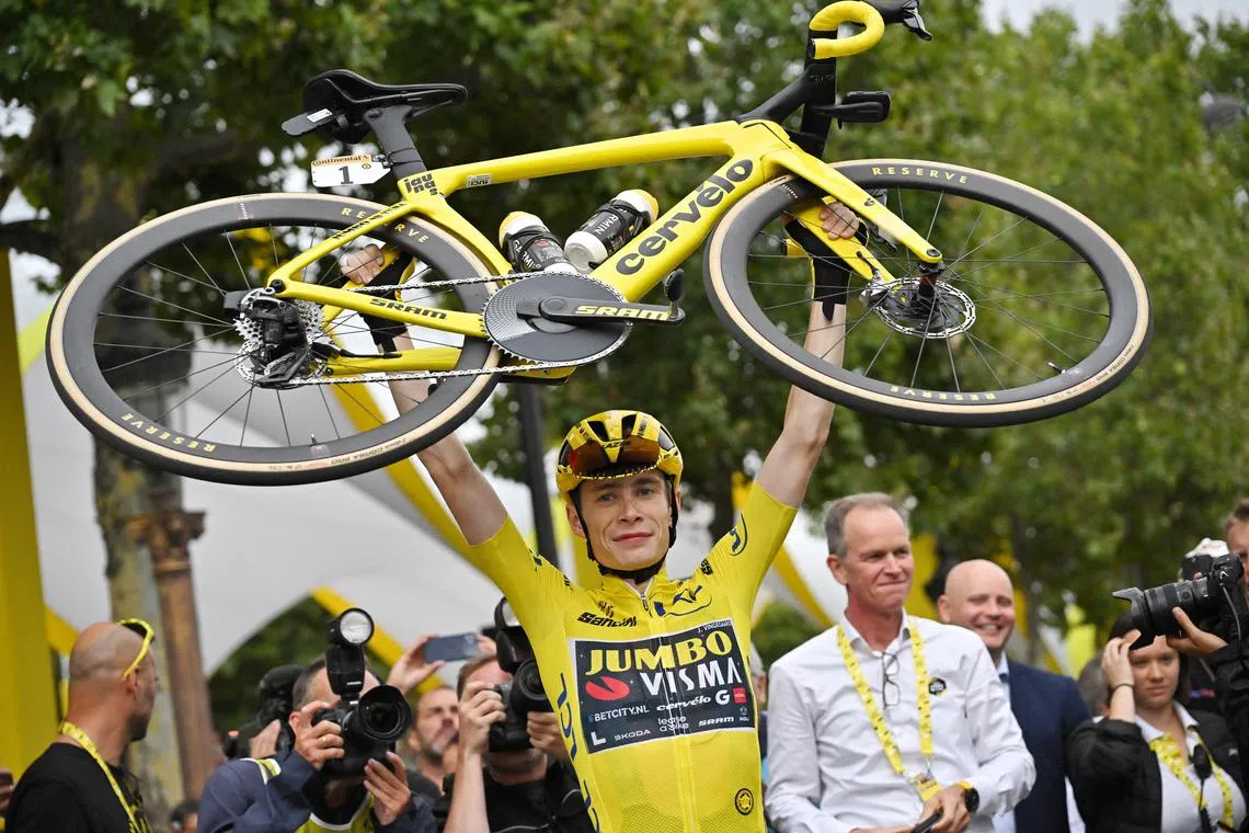 FILE PHOTO: Cycling - Tour de France - Stage 21 - Saint-Quentin-En-Yvelines to Paris Champs-Elysees - France - July 23, 2023 Team Jumbo–Visma's Jonas Vingegaard lifts his bike as he celebrates winning the Tour de France Pool via REUTERS/Marco Bertorello/File Photo