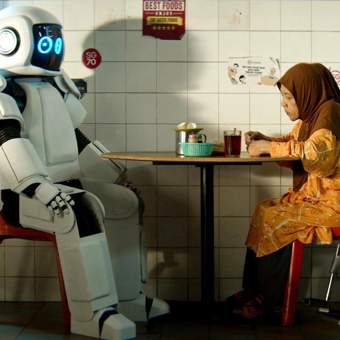 Zaliha Hamid (seated, right) stars in the short film iZ-1, part of the Kopitiam Days anthology.  