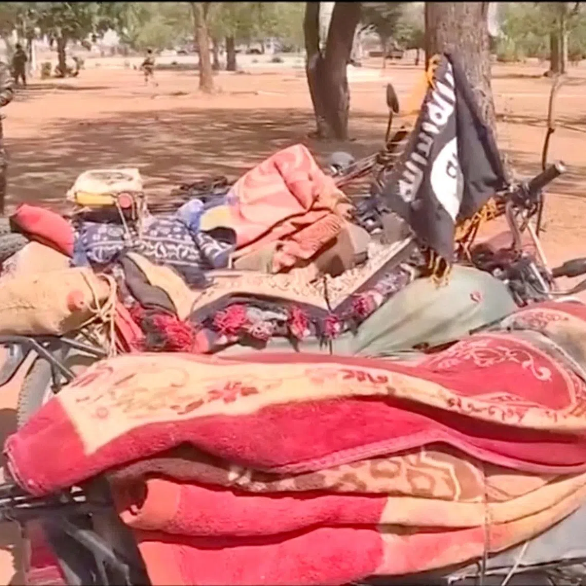 Members of the Nigerien army walk near the motorcycles seized from the attackers, following an attack on Niamey International Airport, in Niamey, Niger January 29, 2026, in this screengrab from a video. ORTN/Reuters TV/Handout via REUTERS