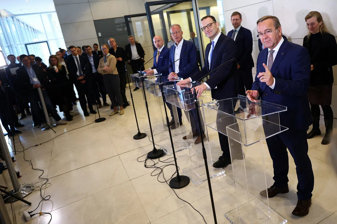 German Defence Minister Boris Pistorius addresses the media with CDU/CSU parliamentary group leader Jens Spahn and Social Democratic Party's (SPD) parliamentary group leader Matthias Miersch at the lower house of parliament, the Bundestag, in Berlin, Germany, November 13, 2025. REUTERS/Lisi Niesner