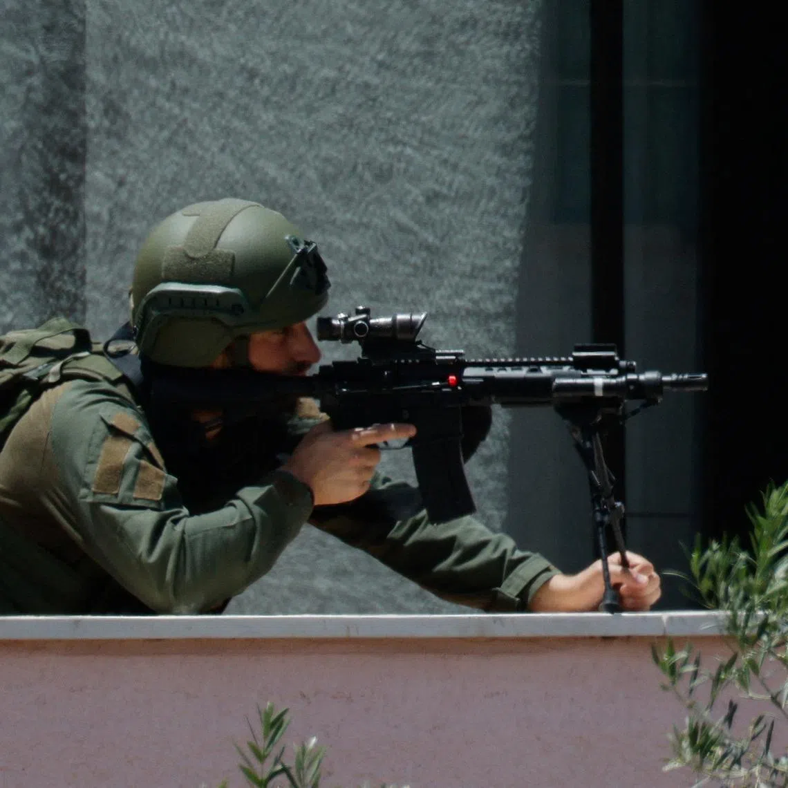 An Israeli soldier looks through the sight of his rifle, at his position near the border with Lebanon, in northern Israel, May 31, 2026. REUTERS/Amir Cohen