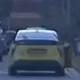 A yellow cab was seen moving with an open door in a video recording posted on Feb 24.