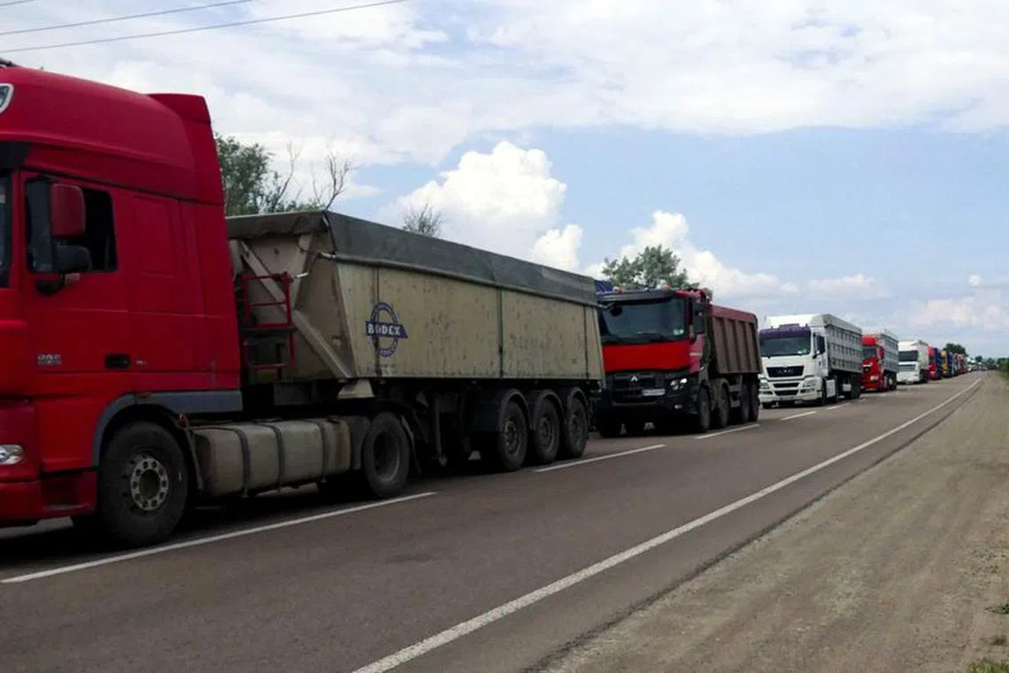 Trucks with grain wait for crossing the Ukraine-Moldova border in Odesa region, as Russia's attack on Ukraine continues, Ukraine June 11, 2022.  REUTERS/Igor Tkachenko/File Photo