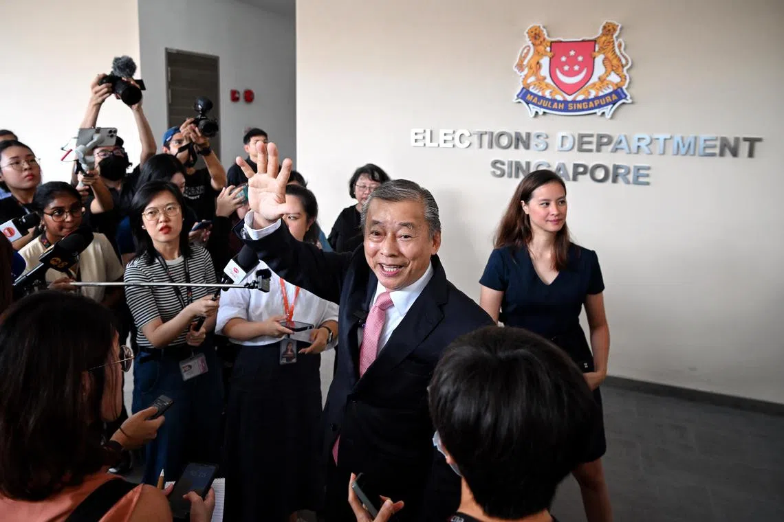 Entrepreneur George Goh waving to the media and supporters to turned up at the Elections Department (ELD) to witness him collecting the papers to apply for Singapore's  presidency on June 13, 2023. He is accompanied by his wife, Lysa Sumali and children, Jovina, Joanna, Ingrid and Jonathan as well his supporters, dressed in red.