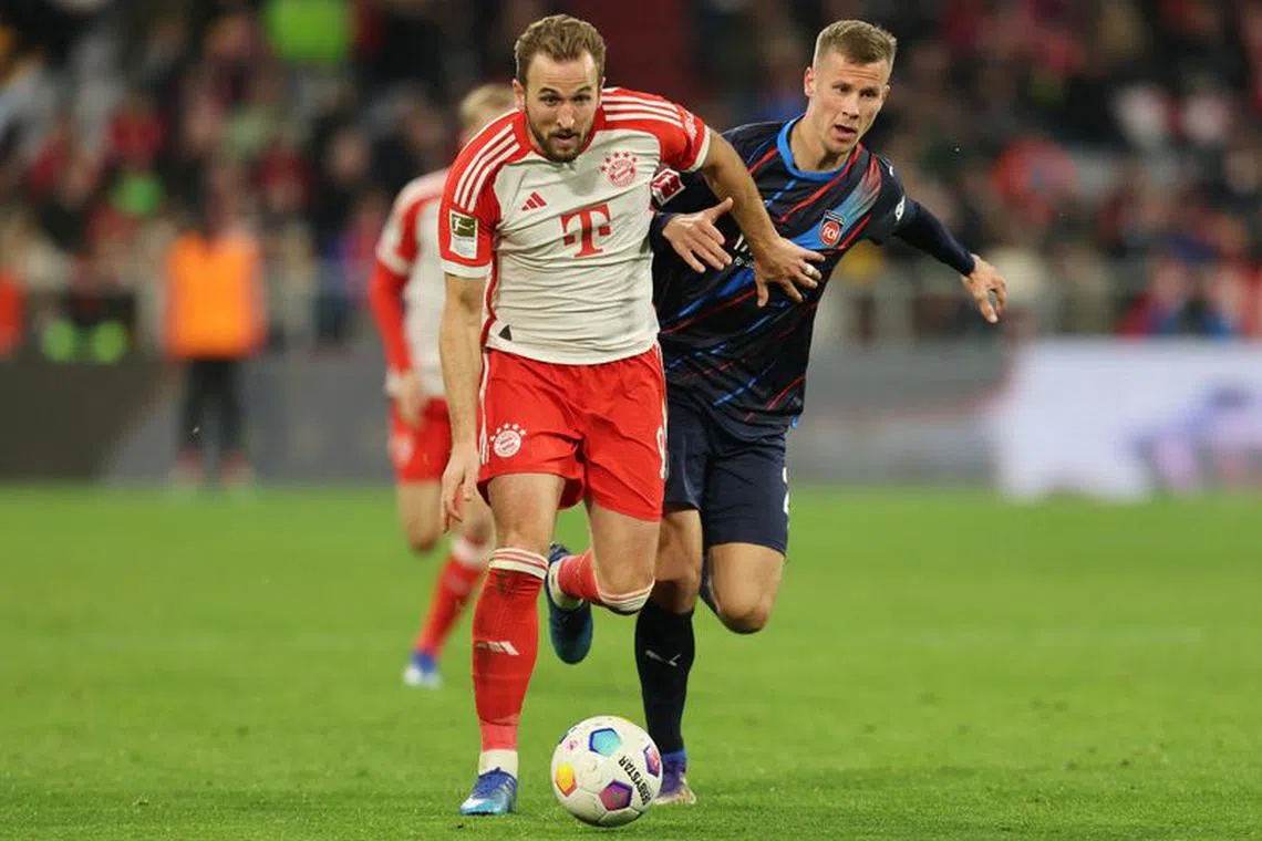 Soccer Football - Bundesliga - Bayern Munich v 1. FC Heidenheim - Allianz Arena, Munich, Germany - November 11, 2023 Bayern Munich's Harry Kane in action with 1. FC Heidenheim's Adrian Beck REUTERS/Leonhard Simon/  File Photo