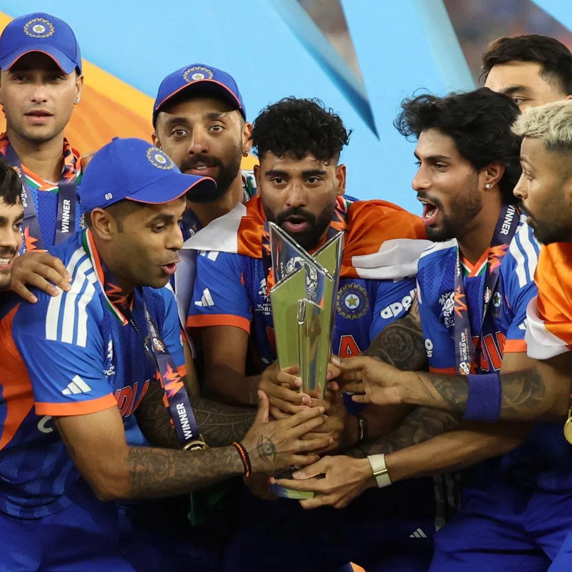 Cricket - ICC Men's T20 World Cup 2026 - Final - India v New Zealand - Narendra Modi Stadium, Ahmedabad, India - March 8, 2026 India's Suryakumar Yadav lifts the trophy with teammates as they celebrate after winning the ICC Men's T20 World Cup REUTERS/Amit Dave