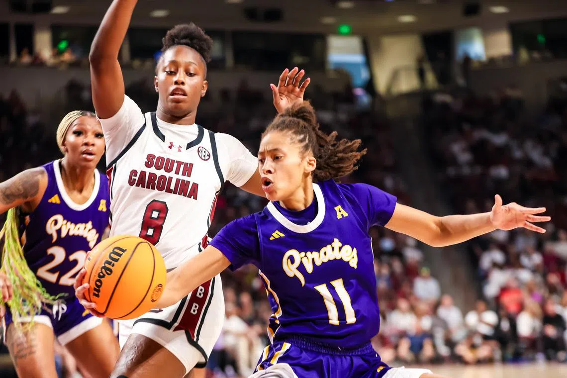 Nov 17, 2024; Columbia, South Carolina, USA; East Carolina Lady Pirates guard Khia Miller (11) grabs a loose ball in front of South Carolina Gamecocks forward Joyce Edwards (8) in the second half at Colonial Life Arena. Jeff Blake-Imagn Images