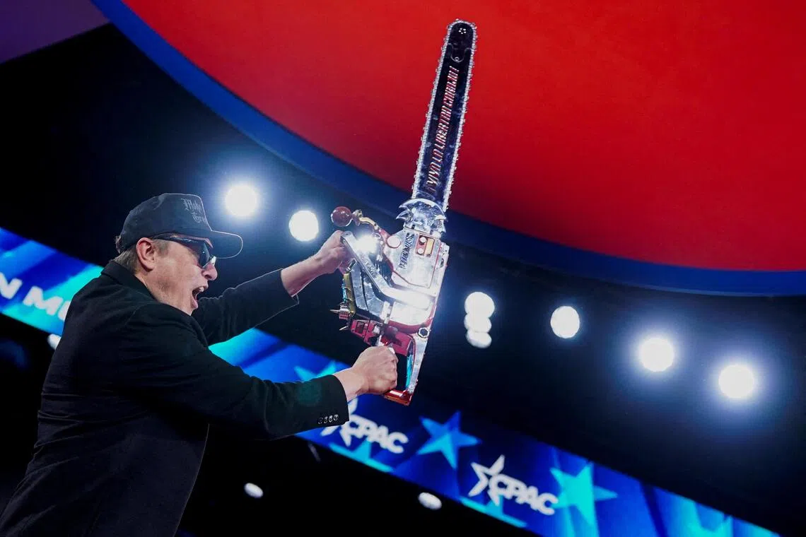 Elon Musk holding up a chainsaw onstage during the Conservative Political Action Conference (CPAC) in National Harbor, Maryland, in the US on Feb 20, 2025.