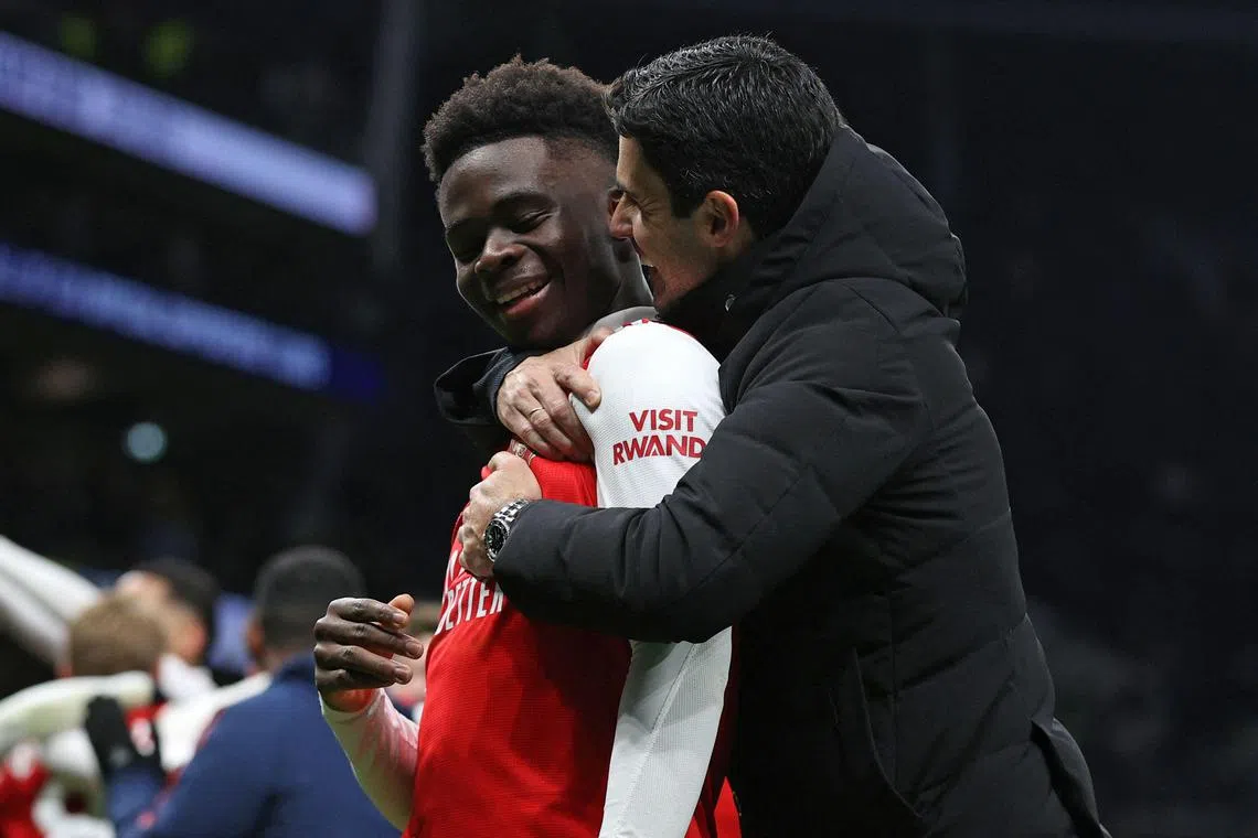 Arsenal's Mikel Arteta (right) celebrates his team's victory after the match with midfielder Bukayo Saka.