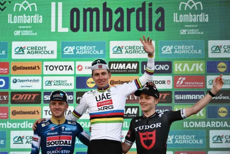 UAE Team Emirates’s Slovenian rider Tadej Pogacar (centre) celebrates his victory on the podium alongside second-placed Soudal Quick-Step’s Belgian rider Remco Evenepoel (left) and third-placed Tudor Pro Cycling Team’s Australian rider Michael Storer (right).