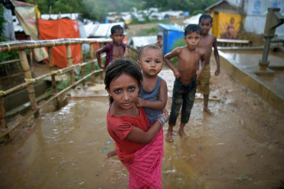At the Rohingya shelters in Cox’s Bazar, Bangladesh, more than 5,500 households are headed by children – because their parents are dead. A young girl looks after her sibling at the Kutupalong camp, childhood is a luxury that some children cannot afford.