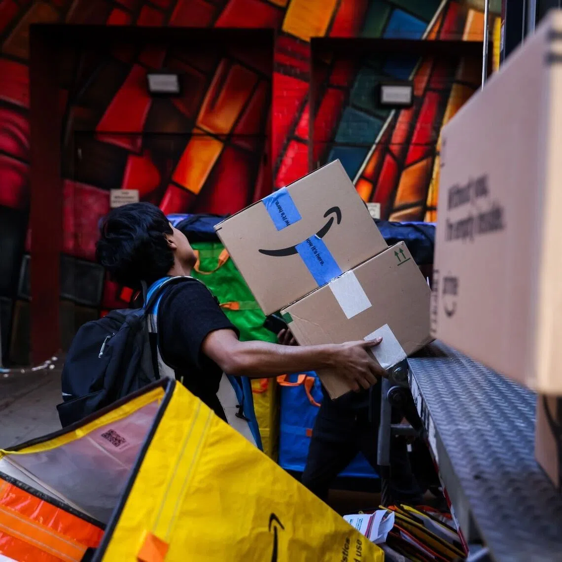 A worker in New York unloading packages from online agent Amazon, which has blocked agentic shopping.