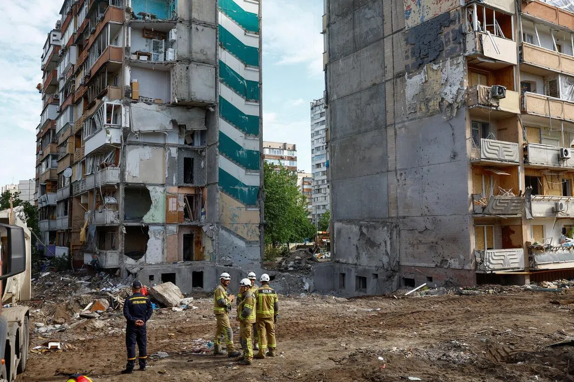Emergency workers at the site of an apartment building hit by a Russian missile strike, in Kyiv, Ukraine, on May 15.