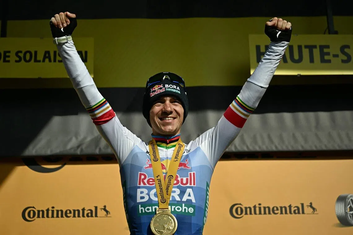 Belgian rider Remco Evenepoel celebrates on the podium after winning the 15th stage of the Tour de France.