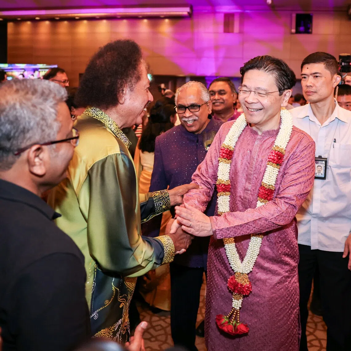 Prime Minister Lawrence Wong shaking hands with guests at the Tamils Representative Council’s 75th anniversary gala dinner.