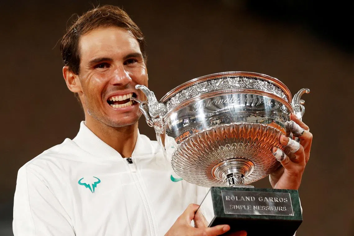 FILE PHOTO: Tennis - French Open - Roland Garros, Paris, France - October 11, 2020 Spain’s Rafael Nadal celebrates with the trophy after winning the French Open final against Serbia’s Novak Djokovic REUTERS/Christian Hartmann/File Photo