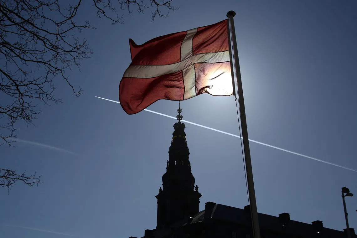 A Danish flag flies in front of Christiansborg Palace, which houses Denmark's parliament, in Copenhagen, Denmark, March 18, 2026. REUTERS/Tom Little