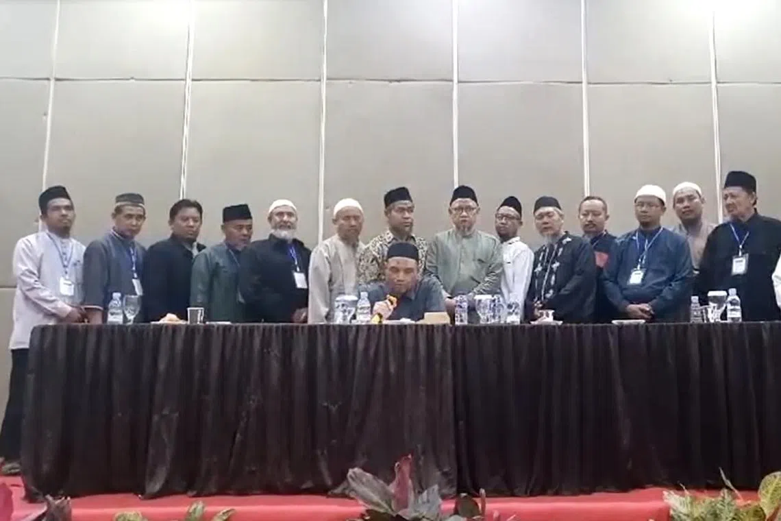 Jemaah Islamiyah in Indonesia's senior leader Abu Rusdan (seated) with other members declaring that the terror group has been dissolved.