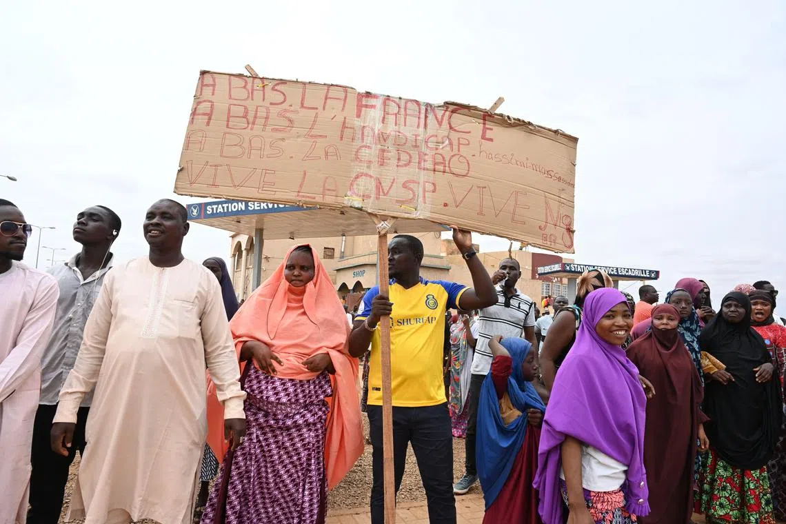 Supporters of Niger's National Council for the Safeguard of the Homeland (CNSP) gather for a demonstration in Niamey on August 11, 2023 near a French airbase in Niger. Thousands of supporters of Niger's coup leaders gathered on August 11, 2023 near a French military base on the outskirts of the capital Niamey. Protesters shouted "down with France, down with ECOWAS", a reference to the West African bloc which on Thursday approved deployment of a "standby force to restore constitutional order" in Niger. (Photo by AFP)