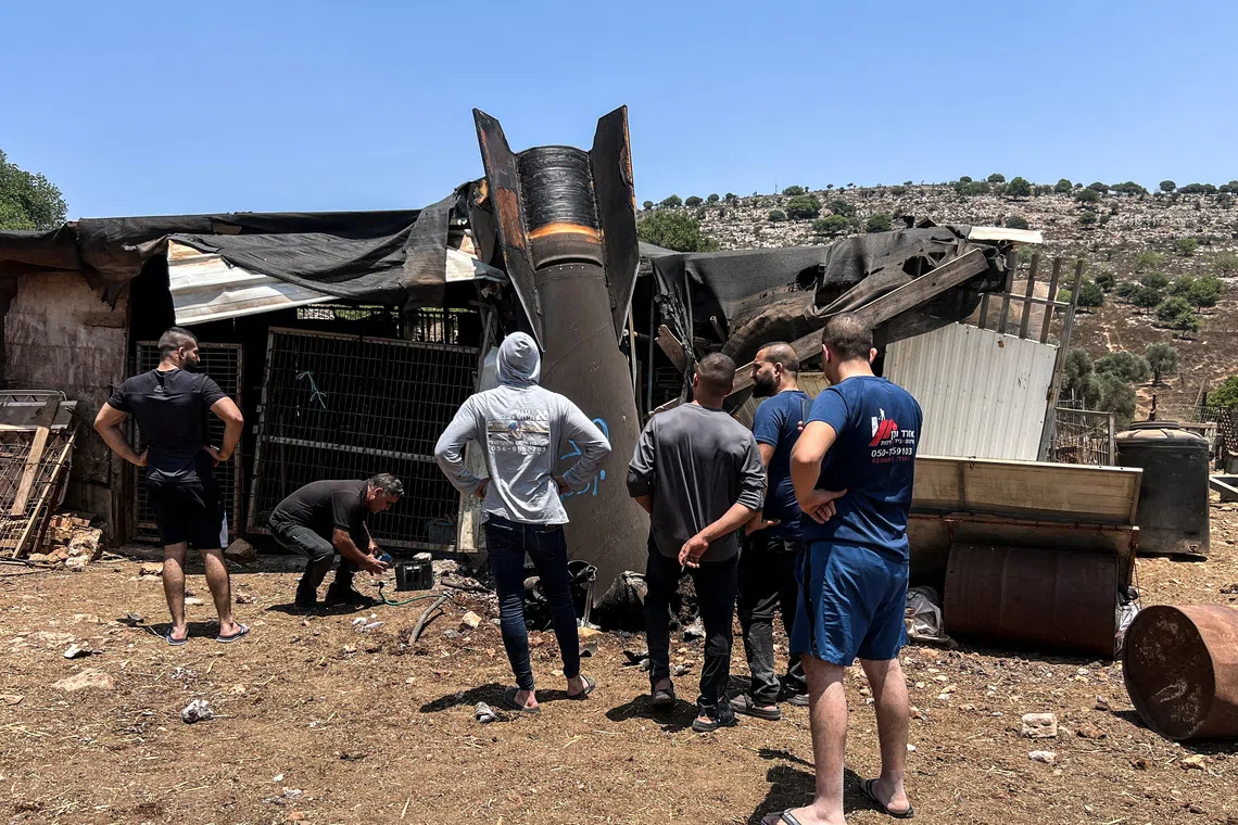 People look at an apparent remains of a ballistic missile following today's missile attack by Iran on Israel, in northern Israel, June 24, 2025. REUTERS/Avi Ohayon