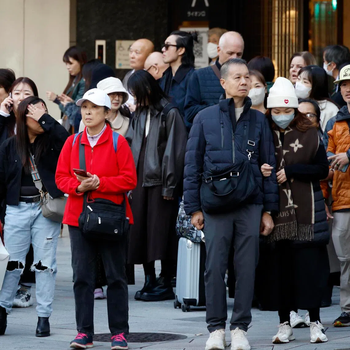 epa12535040 People wait at a crossing in Ginza shopping district of Tokyo, Japan, 19 November 2025. China's Foreign Ministry and its embassy in Japan advised Chinese citizens against future travel to Japan following recent remarks by the Japanese Prime Minister concerning Taiwan. Amid the diplomatic row, several Chinese travel agencies have stopped selling Japan-bound tours, and Japanese hotels are already seeing trip cancellations.  EPA/FRANCK ROBICHON