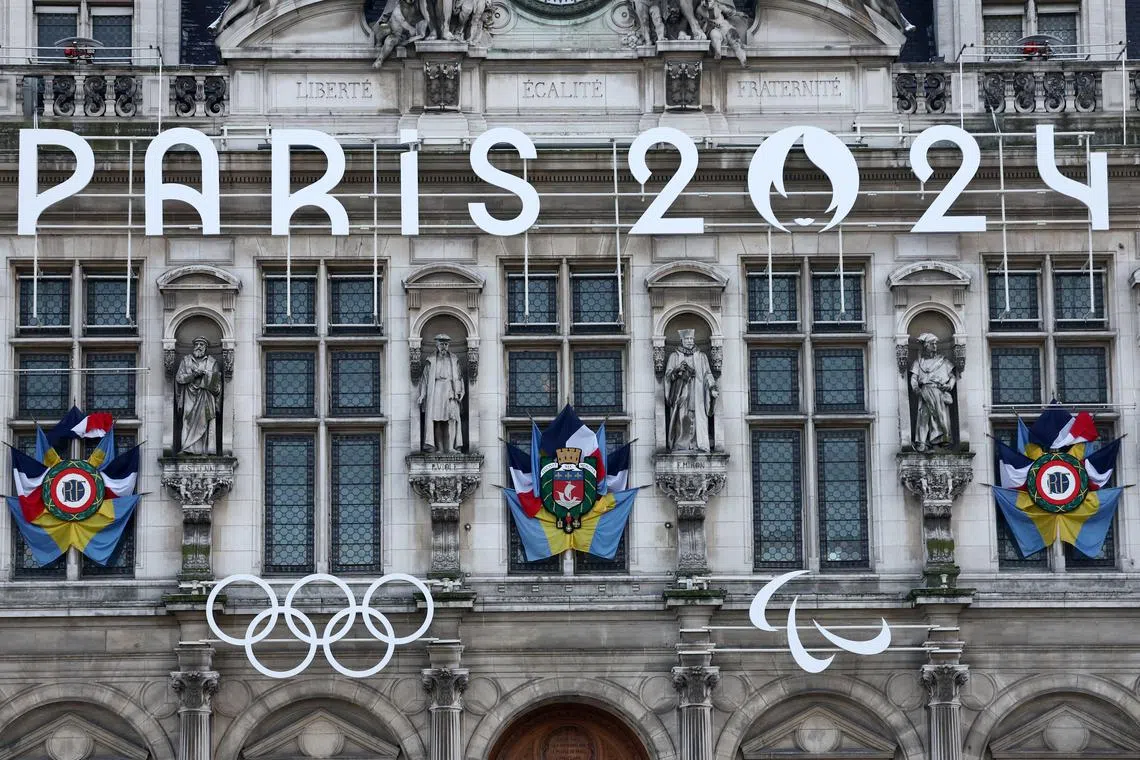 FILE PHOTO: The logo of the Paris 2024 Olympics and Paralympics Games and the Olympics rings are seen on the facade of the Paris city hall in Paris, France, January 18, 2024. REUTERS/Stephanie Lecocq/File Photo