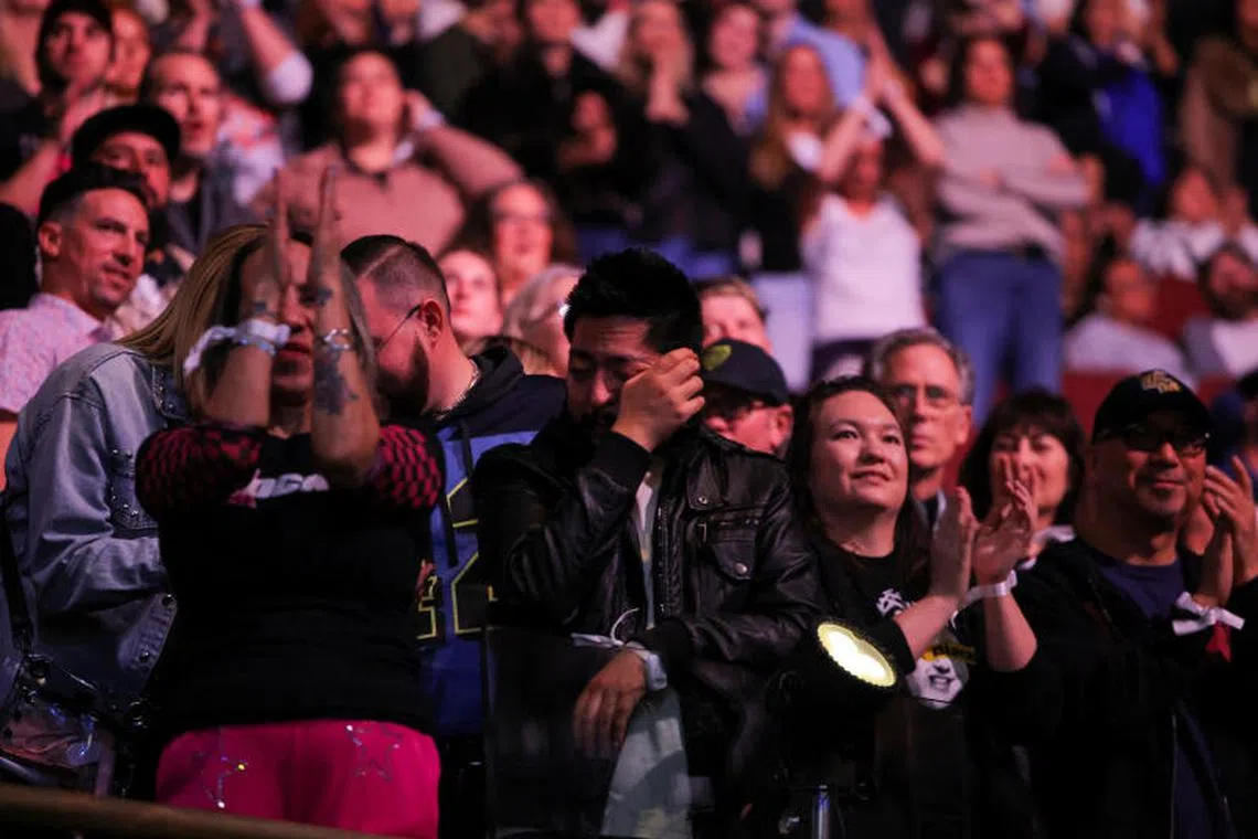 People react during the FireAid benefit concert for Los Angeles wildfire relief efforts, in Inglewood, California, U.S., January 30, 2025. REUTERS/Daniel Cole