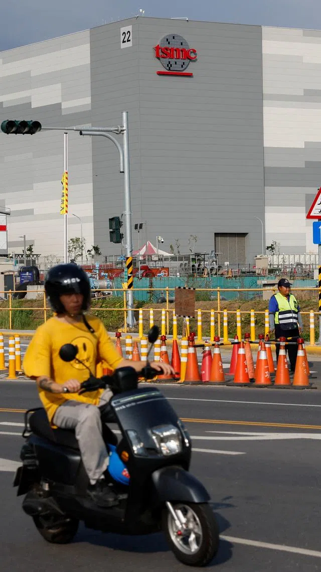 Motorcyclists pass a Taiwan Semiconductor Manufacturing Company (TSMC) facility in Kaohsiung, Taiwan, May 15, 2026. REUTERS/Ann Wang