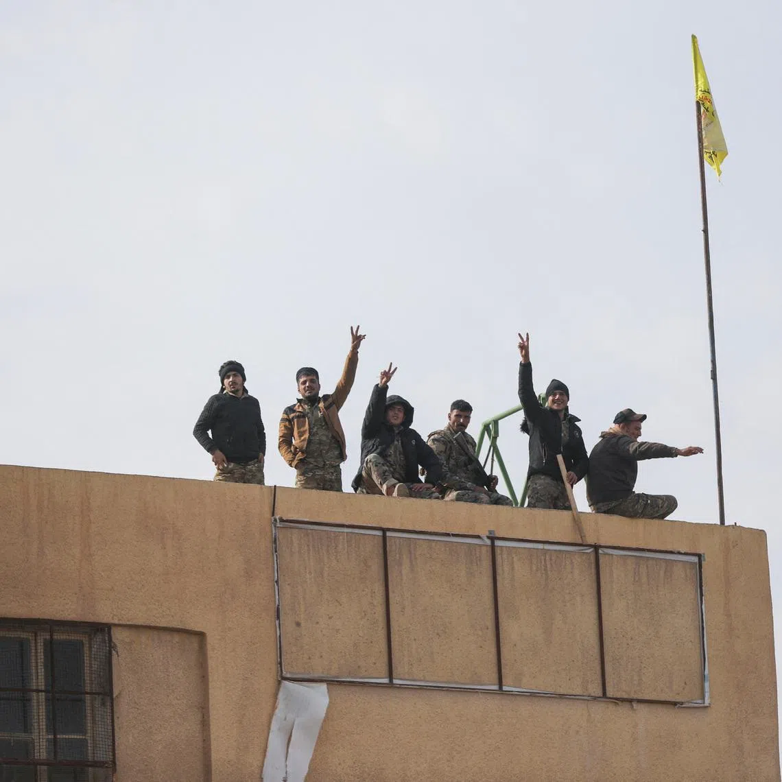 Members of the Kurdish-led Syrian Democratic Forces (SDF) gesture in Deir al-Zor, after U.S.-backed alliance led by Syrian Kurdish fighters captured Deir el-Zor, the government's main foothold in the vast desert, according to Syrian sources, in Syria December 7, 2024. REUTERS/Orhan Qereman/File Photo