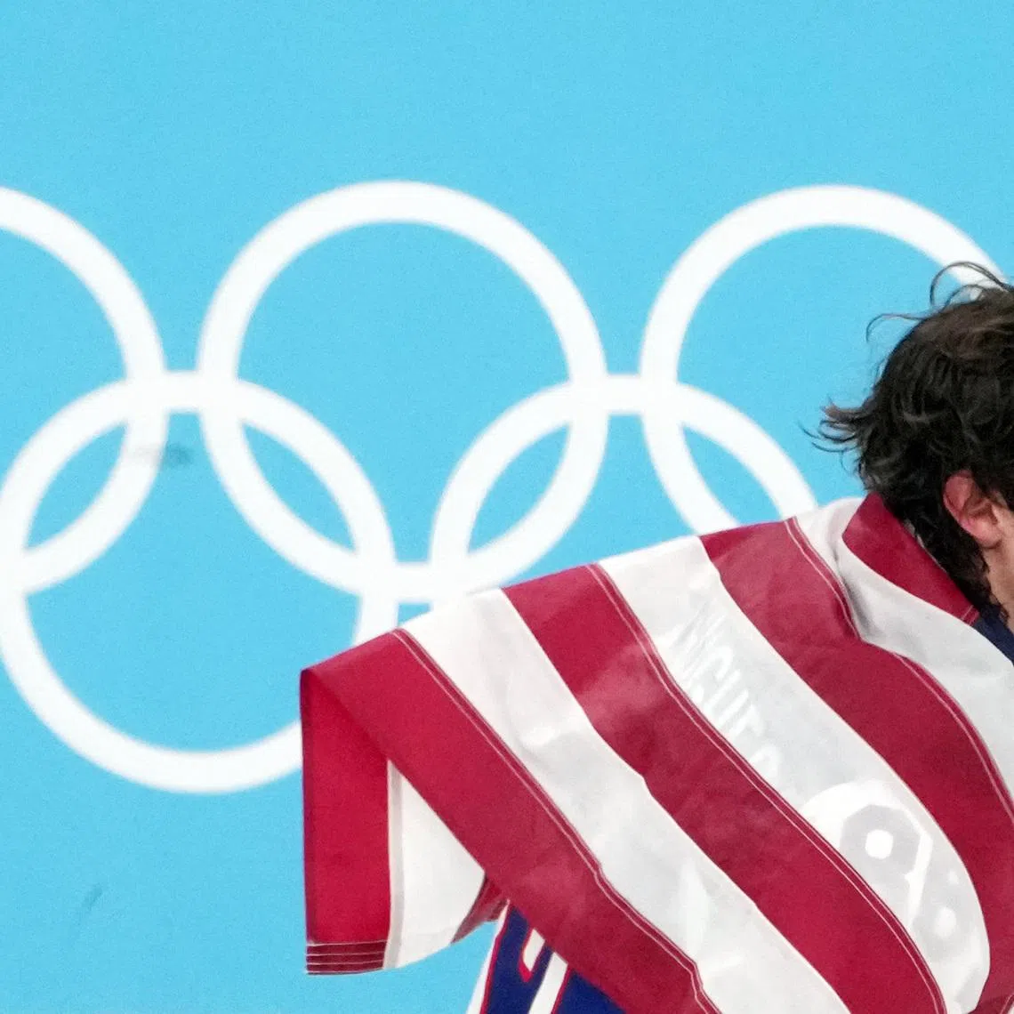 Feb 22, 2026; Milan, Italy; Jack Hughes of the United States celebrates after winning the men's ice hockey gold medal game during the Milano Cortina 2026 Olympic Winter Games at Milano Santagiulia Ice Hockey Arena. Mandatory Credit: James Lang-Imagn Images