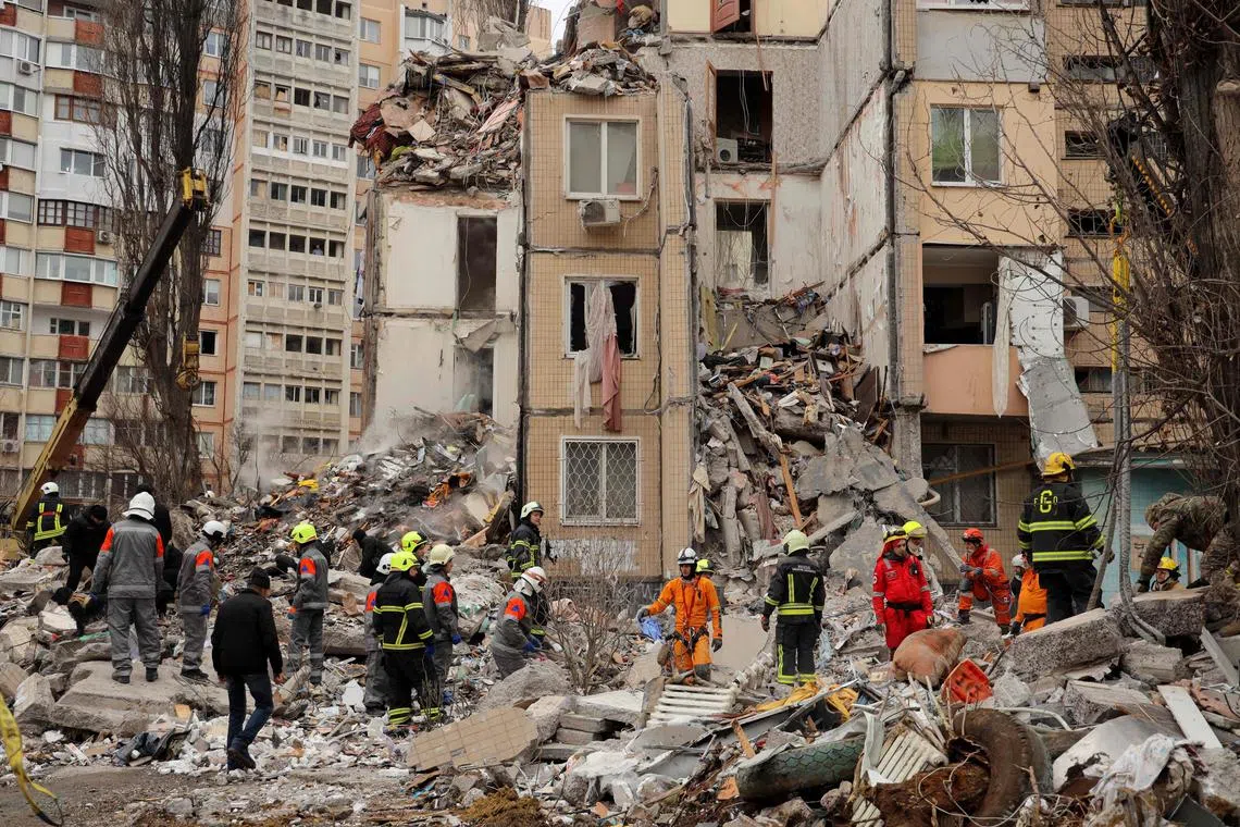 Rescuers work at a heavily damaged multi-story apartment building, following a Russian drone attack, in Odesa, on March 2, 2024. 