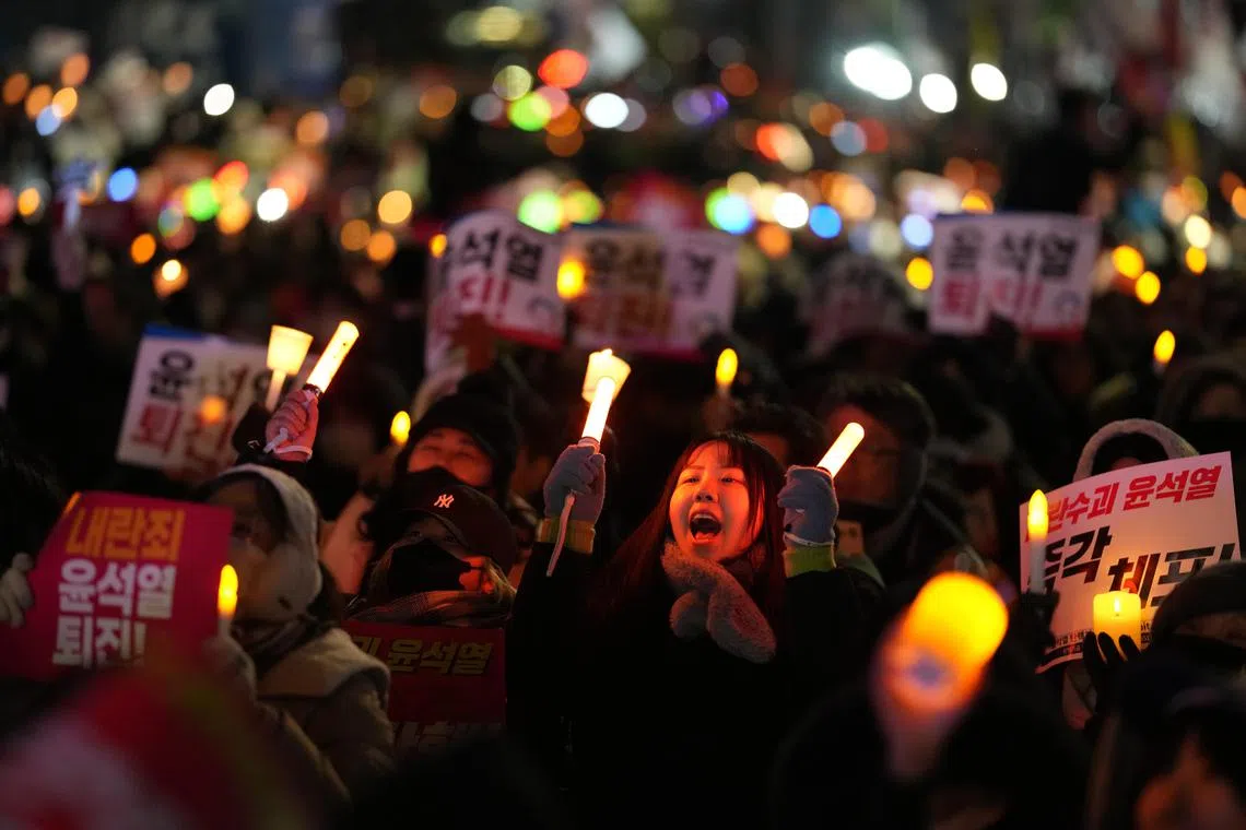 Demonstrators rally outside South Korea's National Assembly in Seoul, calling on President Yoon Suk Yeol to resign or be impeached, on Dec 6. 
