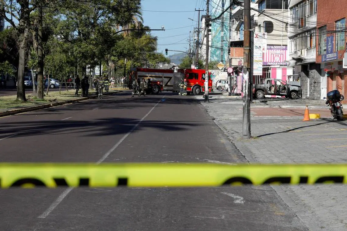 A firetruck is parked at the scene as firefighters work on the remains of a car, that according to authorities was loaded with two gas tanks and later exploded when suspects set it on fire, seemingly targeting Ecuador's prison agency SNAI, in Quito, Ecuador August 31, 2023. REUTERS/Karen Toro
