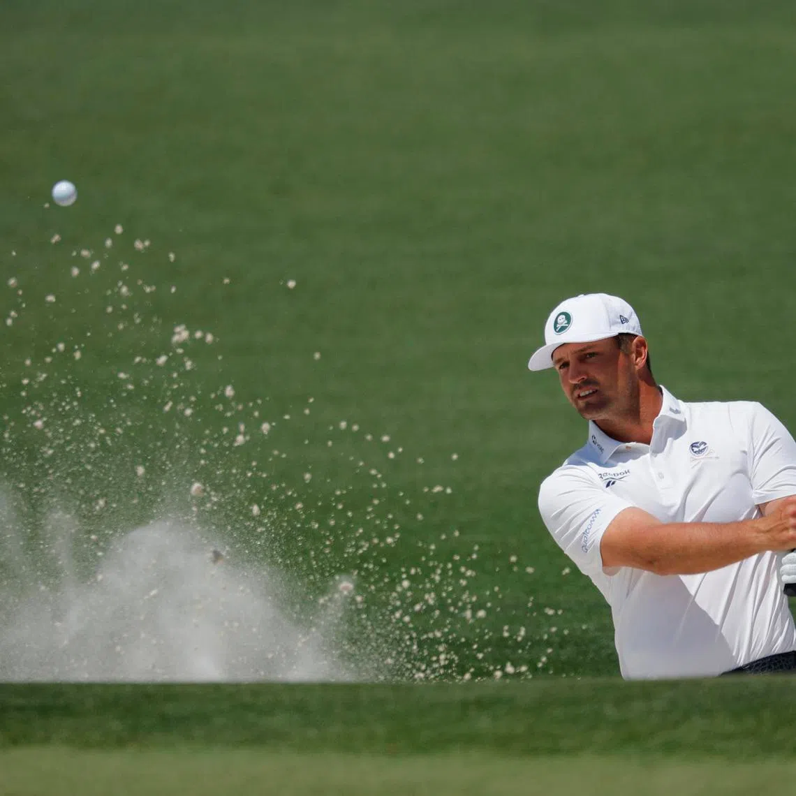 Golf - The Masters - Augusta National Golf Club, Augusta, Georgia, U.S. - April 10, 2026 Bryson DeChambeau of the U.S. plays out from the bunker on the 2nd hole during the second round REUTERS/Mike Blake