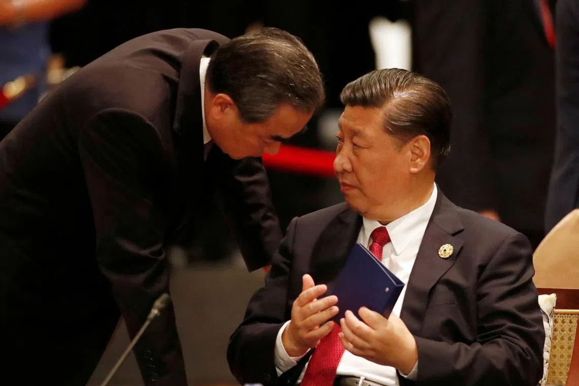 FILE PHOTO: China's President Xi Jinping speaks to Foreign Minister Wang Yi during the APEC-ASEAN dialogue, on the sidelines of the APEC summit, in Danang, Vietnam November 10, 2017. REUTERS/Jorge Silva/File Photo