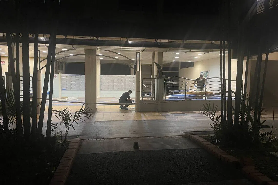Crime Scene Investigation (CSI) officers collecting evidence under Block 57 Telok Blangah Heights.