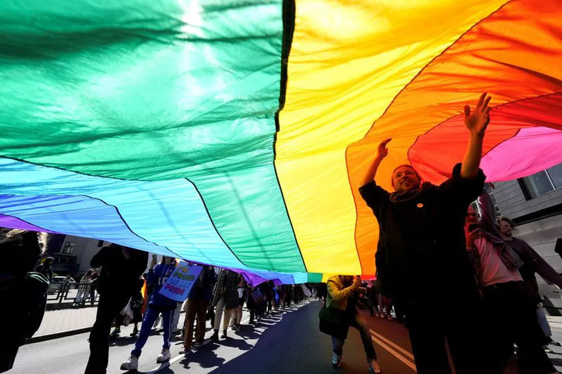 FILE PHOTO: People hold a giant rainbow flag as they walk during Riga Pride 2023 parade in Riga, Latvia June 3, 2023. REUTERS/Ints Kalnins/File photo