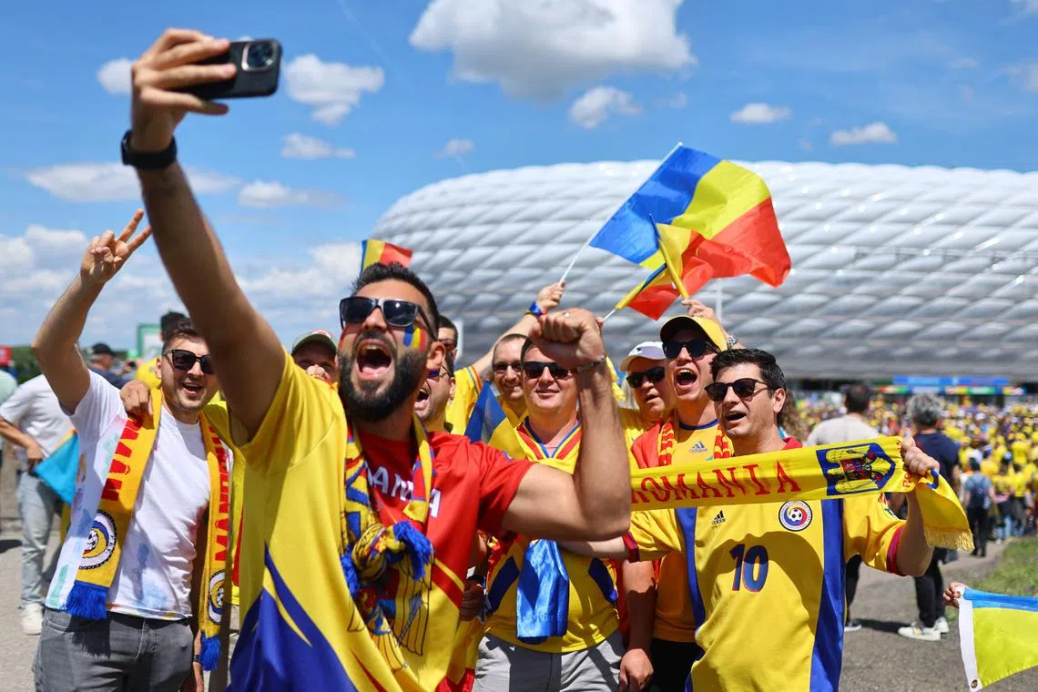 Soccer Football - Euro 2024 - Group E - Romania v Ukraine - Munich Football Arena, Munich, Germany - June 17, 2024 Romania fans take a selfie outside the stadium before the match REUTERS/Leonhard Simon