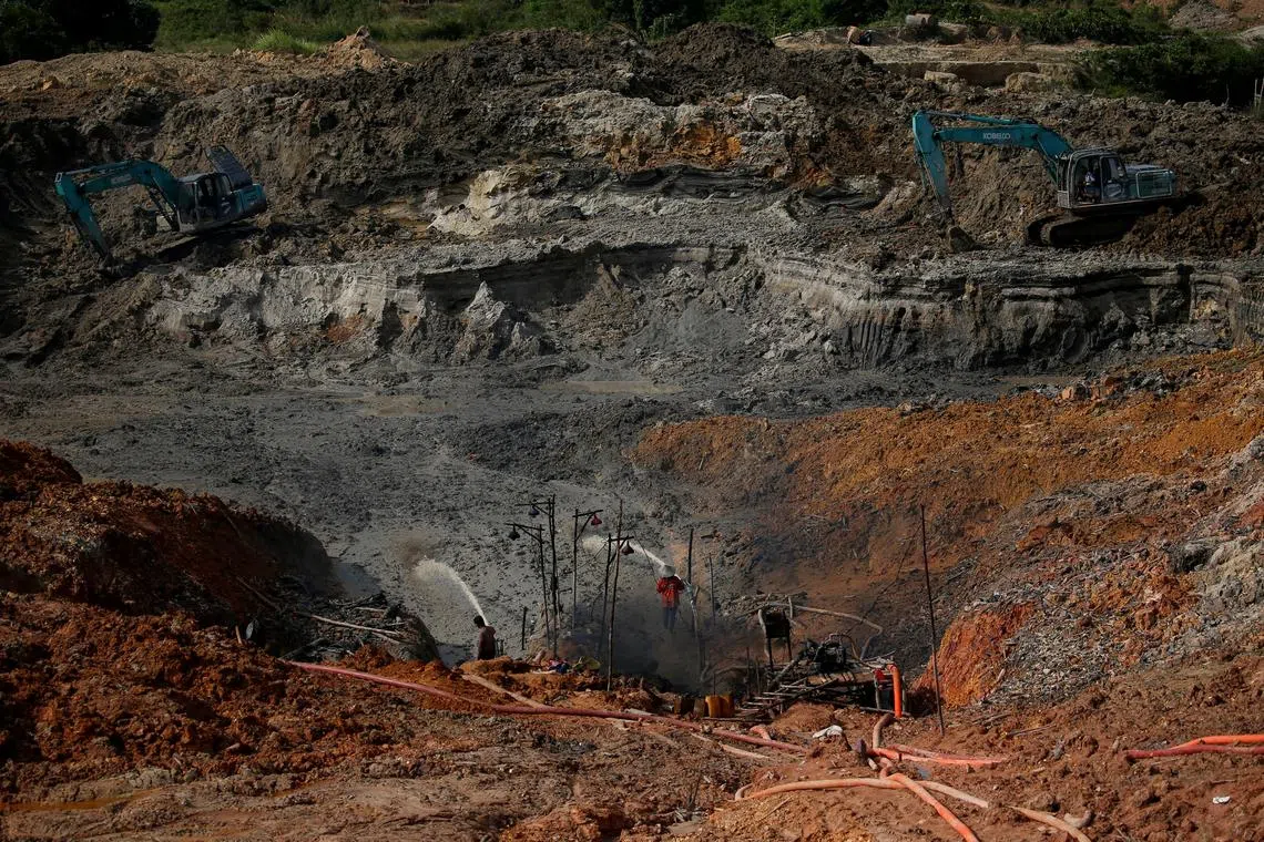 FILE PHOTO: Unlicensed miners work in a tin mining area in Toboali, on the southern shores of the island of Bangka, Indonesia, April 29, 2021. REUTERS/Willy Kurniawan/File Photo