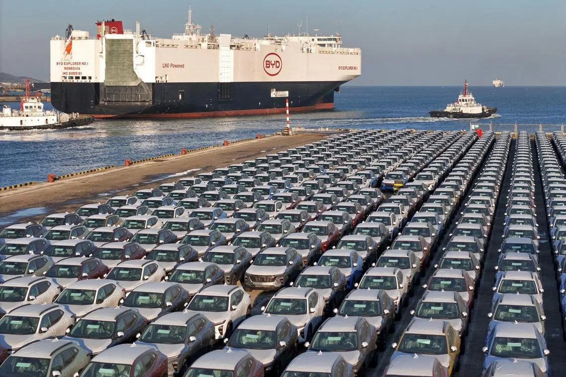 (FILES) This photo taken on January 10, 2024 shows electric cars for export waiting to be loaded on the "BYD Explorer NO.1", a domestically manufactured vessel intended to export Chinese automobiles, at Yantai port, in eastern China's Shandong province. Leading Chinese electric car maker BYD's vehicle sales surged in 2024, the company said in a statement, as the firm grows its overseas presence. (Photo by AFP) / China OUT