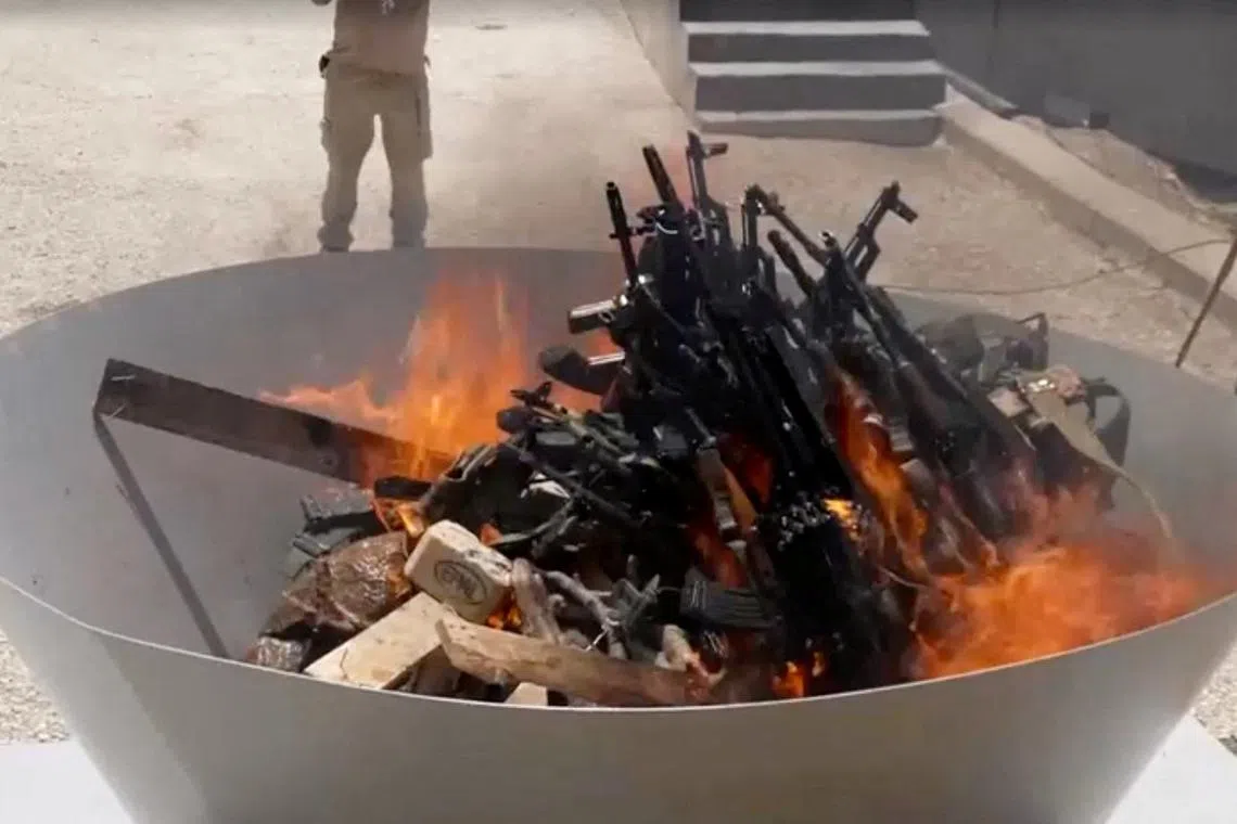 Weapons placed by PKK fighters are burnt during a disarming ceremony in Sulaimaniya, Iraq, July 11, 2025, in this screengrab obtained from a handout video. KURDISTAN WORKERS PARTY MEDIA OFFICE/Handout via REUTERS/File Photo