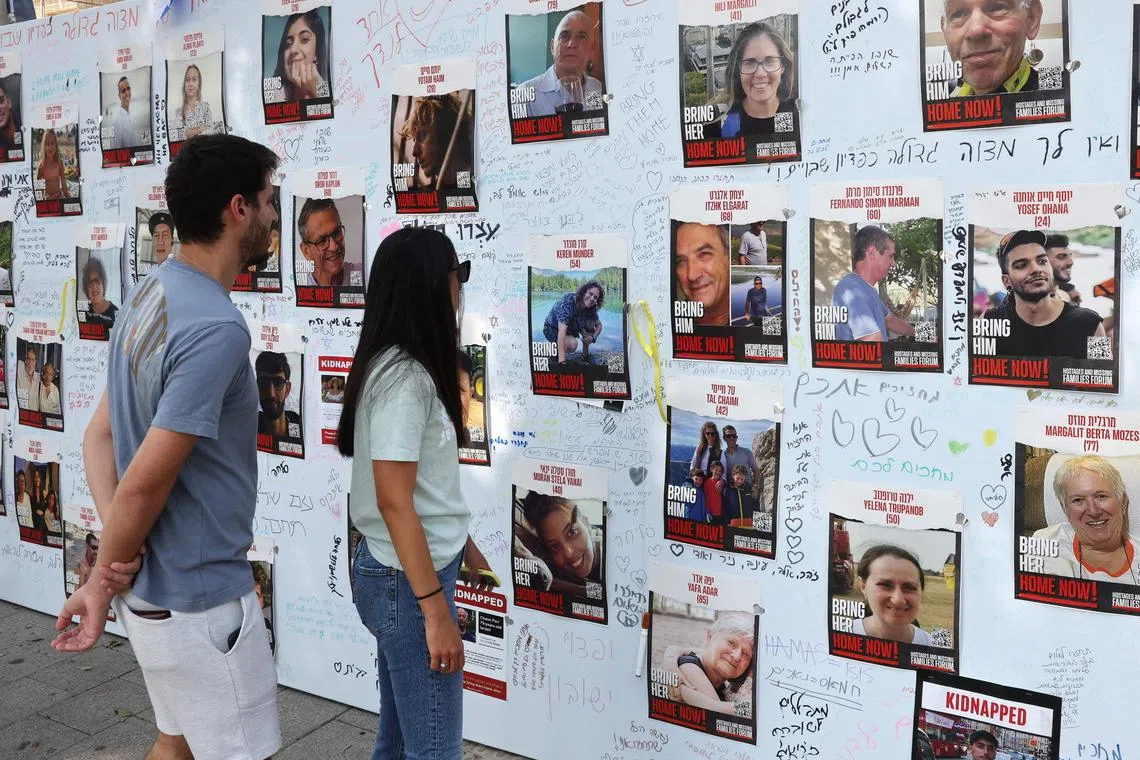 People looking at portraits of Israeli hostages held by Hamas gunmen since the Oct 7 attack on Israel.