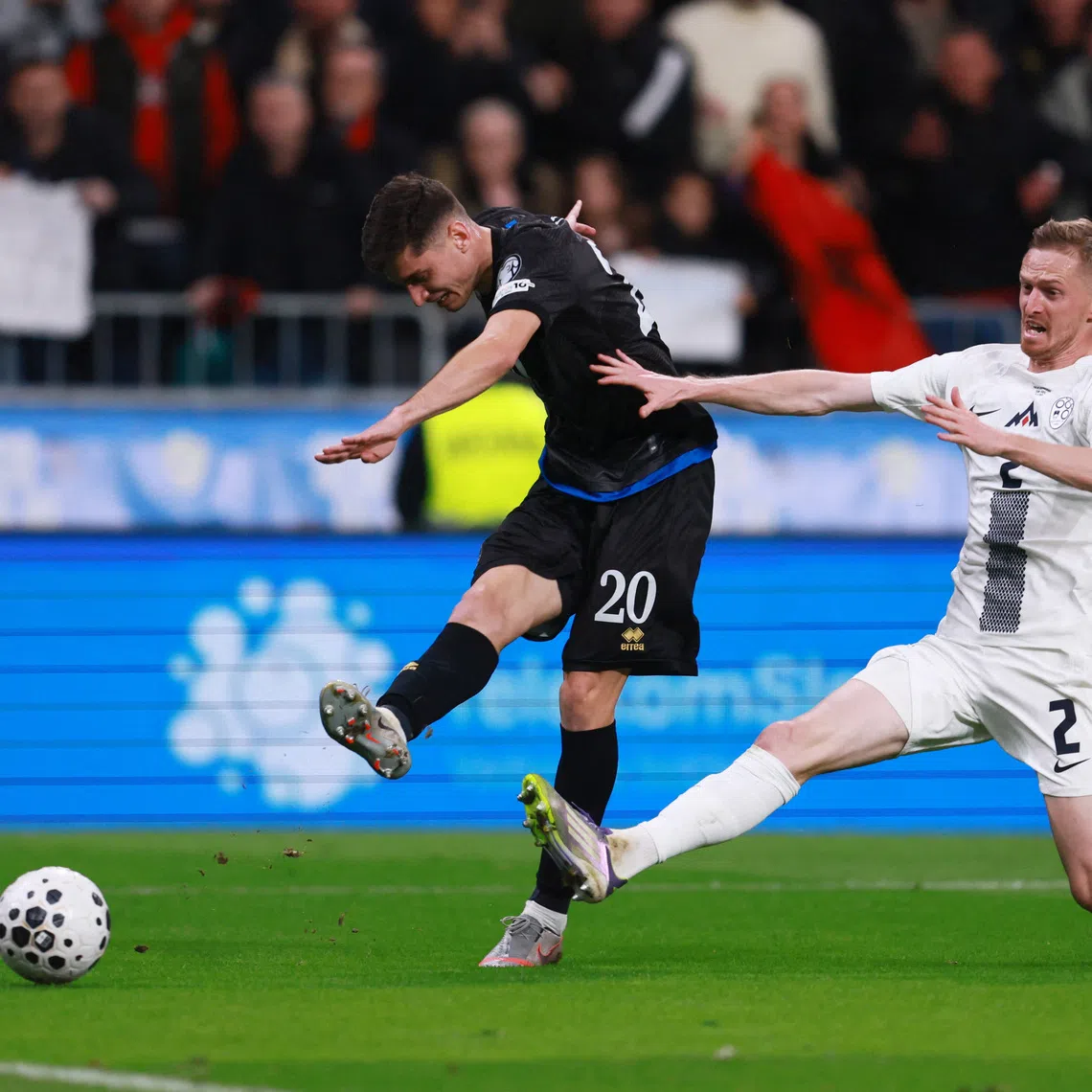 Soccer Football - FIFA World Cup - UEFA Qualifiers - Group B - Slovenia v Kosovo - Stadion Stozice, Ljubljana, Slovenia - November 15, 2025 Slovenia's Zan Karnicnik in action as Kosovo's Veldin Hodza shoots at goal REUTERS/Borut Zivulovic
