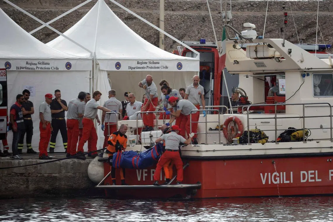 Rescuers carrying the body of British tech magnate Mike Lynch near the Sicilian city of Palermo on Aug 22.