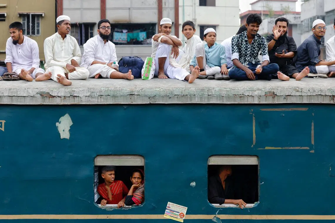 People travelling on the rooftop of an overcrowded train, in Dhaka, Bangladesh, on Aug 7, 2025. 
